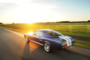 1965 Shelby GT350CR driving down the road at sun set